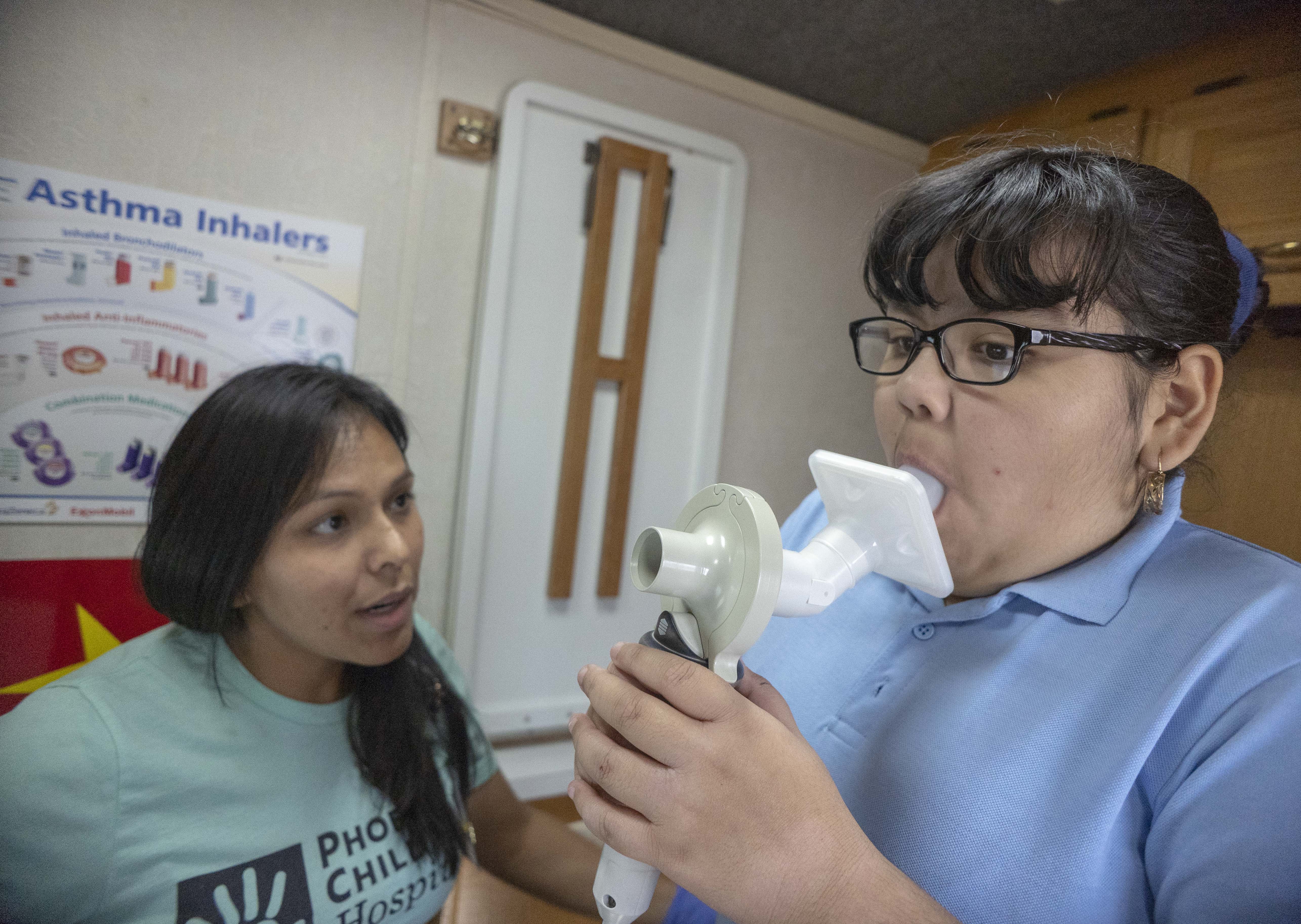 Debby Tavizon-Stanton, a registered nurse from Phoenix Children Hospital, tests Karen Carranza, 10, for asthma at Sunset Elementary School. The Breathmobile, an asthma clinic on wheels, visiting.
